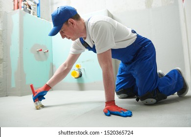 Floor Waterproofing In Bathroom. Worker Adding цater Resistant, Protective Coating