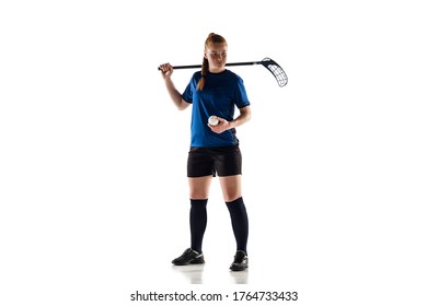Floorball female player isolated on white studio background. Action and motion, movement, healthy lifestyle and overcoming concept. Young caucasian woman in sportwear training, practicing the game.