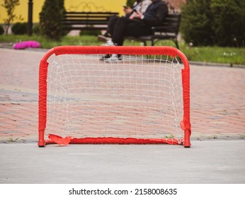 Floorball Goal Ready For Training. Children Playing Outdoor In Spring. Floor Hockey Players Goalkeeper Running With Ball And Sticks. Outside Leisure, Active Lifestyle Kids Sport.