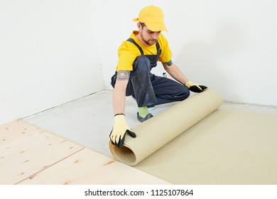 flooring work. underlayer installation at preparation for wood parquet floor - Shutterstock ID 1125107864