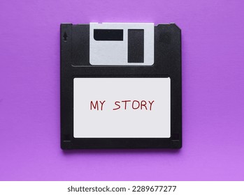 Flopppy disk on purple background with text written MY STORY, concept of first time book writing, author start his novel, creative writing to get published
