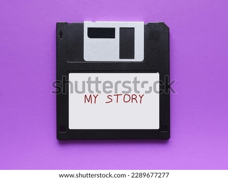 Flopppy disk on purple background with text written MY STORY, concept of first time book writing, author start his novel, creative writing to get published Photo stock © 