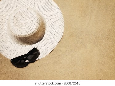 a floppy beach hat and sunglasses