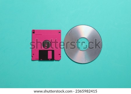 Floppy disk and cd on a blue background. top view