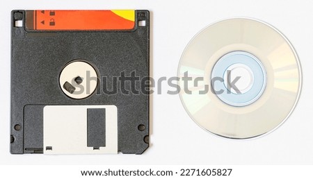 Floppy disk and cd disk on a light background. Information carriers.