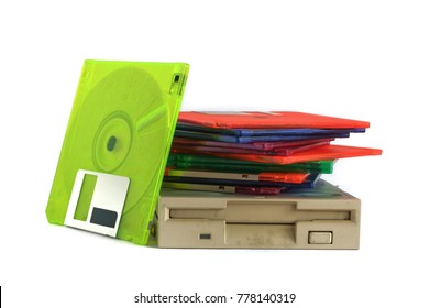 Floppy disk drive and diskettes on white background, old technology and legacy industrial computer equipment
