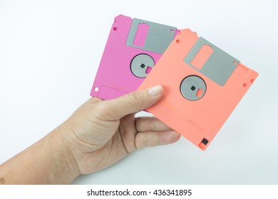 floppy disk in hands on the white background