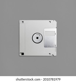 Floppy disk on gray paper background. Gray diskette. Top view. Flat lay.
