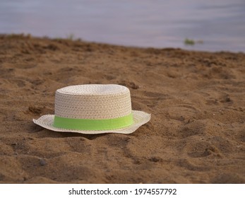 Floppy Straw Hat Left By Water Side In The Sand Medium Shot