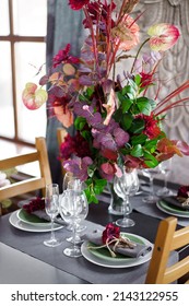 Floral Arrangement On The Dining Table With Decor. Family Dinner And Table Setting.