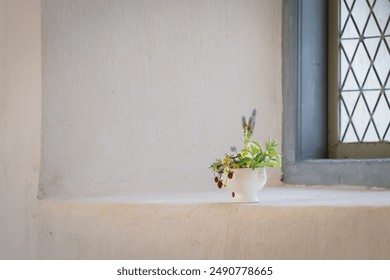 Floral arrangement with strawberries and summer flowers. Floral arrangement on a church window sill. Interior. - Powered by Shutterstock