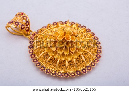 Floral circular golden pendent with small gems slide view isolated on white background.