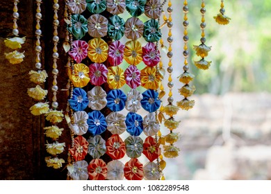 Floral Decoration In Buddhist Temple. Cambodian Temple Internal Floral Decor. Buddhism Festival Decoration. Handmade And Natural Flower Garland. Festive Religious Ritual In South Asia