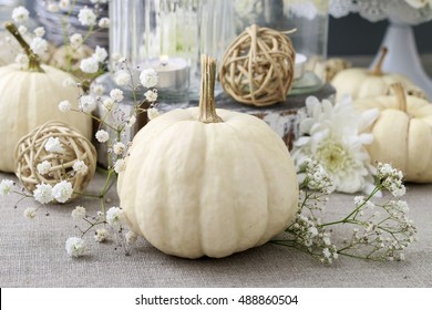 Floral decoration with white pumpkins called baby boo and chrysanthemum flowers.