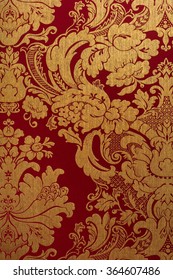 Floral gold and red pattern on seamless background.
