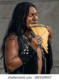 Floral Park, New York, U.S.A - July 28, 2018: Native American Man Playing The Flute At The Queens County Farm Pow Wow.