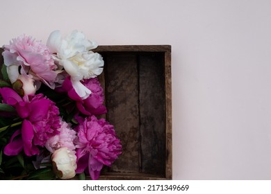 Floral pattern, beautiful pink peonies on wooden white background. Flat lay, top view. Wedding background. Floral frame. Frame of flowers. Flowers texture