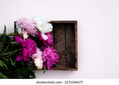 Floral pattern, beautiful pink peonies on wooden white background. Flat lay, top view. Wedding background. Floral frame. Frame of flowers. Flowers texture