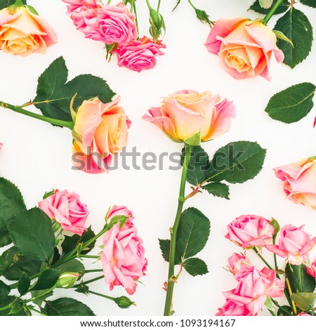 Floral pattern with colorful roses, buds and green leaves on white background. Flat lay, top view. Spring background