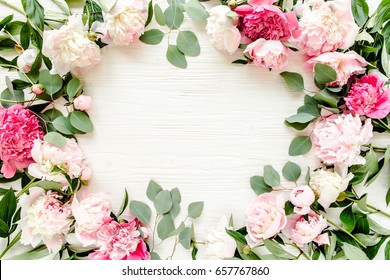 Floral pattern, frame made of beautiful pink peonies on wooden white background. Flat lay, top view. Valentine's background. Floral frame. Frame of flowers. Flowers texture