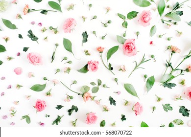 Floral pattern made of pink and beige roses, green leaves, branches on white background. Flat lay, top view. Valentine's background