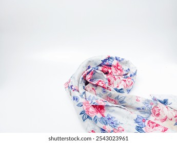 A floral scarf is rolled up and placed on a white surface. The scarf is white with pink, blue, and purple flowers.
 - Powered by Shutterstock