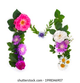 Floral summer font. Concept alphabet design, letter M. Seasonal decorative beautiful type mades of different multi-colored blooming flowers and grass. Natural summertime print