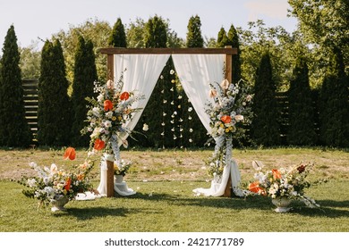 Floral wedding arch outdoors in sun light. - Powered by Shutterstock