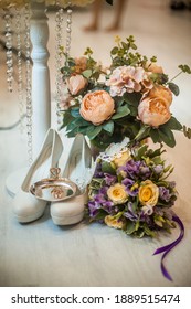 Floral wedding decoration. Wedding floristry. A bouquet of roses. White bride shoes wedding rings