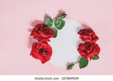 Floral wreath made of roses and leaves. Natural round frame isolated on pink. Holiday concept. - Powered by Shutterstock