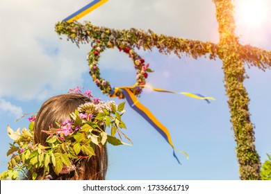 With Floral Wreath On Midsummer Tree In Sweden