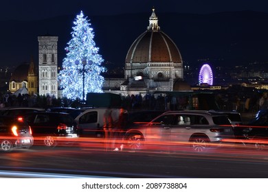 Florence, 12 December 2021: The Cathedral of Santa Maria del Fiore with illuminated Christmas tree and ferris wheel on the right seen from Michelangelo square in Florence. Italy