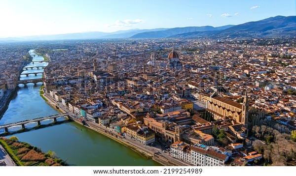 Florence,\
capital of Italy’s Tuscany region, is home of Renaissance art and\
architecture. Aerial view iconic sight  of Santa Maria del Fiore\
with beautiful city landscape and Arno\
River