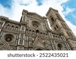 Florence Cathedral facade in Italy - Duomo di Firenze. Beautiful religious building with cloudy sky