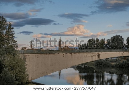 Florence cityscape with clouds and water reflections on Arno river in Florence, Italy