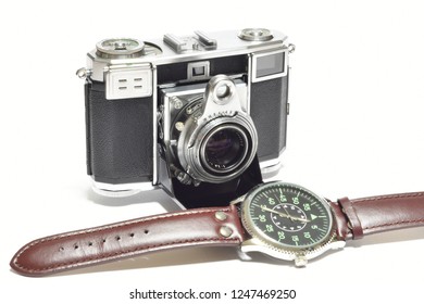 Florence, December 2018: Old Vintage Camera and watch isolated on white background