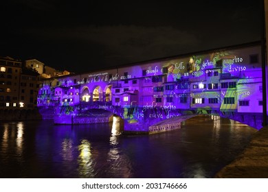 Florence, December 2020: The Famous Old Bridge over Arno river, illuminated on the occasion of Firenze Light Festival. Italy.