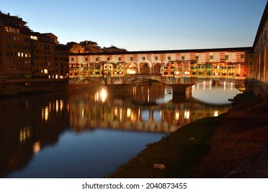 Florence, December 2020: The Famous Old Bridge over Arno river, illuminated on the occasion of Firenze Light Festival, entitled in homage to Dante "Sight, from the dark forest to the light". Italy.