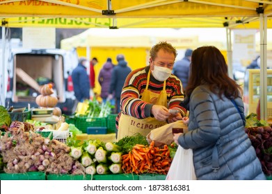 Florence, Italy - 2020, December 12: Shopping To The Greengrocer, At The Local Market. Cash Payment. Protective Masks.