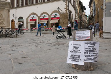 
Florence, Italy - 2020, May 18: People Walking On The City Street During Covid-19 Lockdown. Headlines In The Foreground.