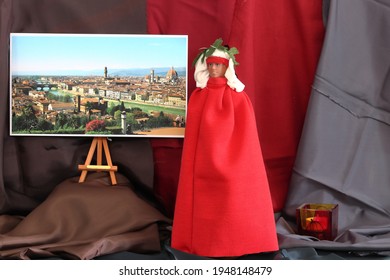 Florence (Italy) April 2021 - Toy Depicting A Dante Character With A Painting Of Florence.