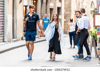 Florence, Italy - August 30, 2018: Narrow Alley Street In Firenze Tuscany During Day With Young People Couple Holding Hands Walking By Restaurant