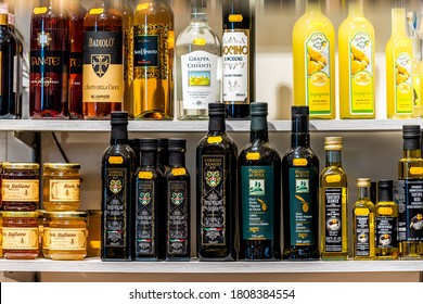 Florence, Italy - August 30, 2018: Firenze Mercato Central Market Closeup Of Olive Oil And Liquor Bottles Sign Price In Retail Display In Stall