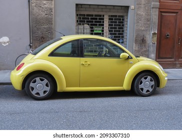 FLORENCE, ITALY - CIRCA DECEMBER 2021: Yellow Volkswagen New Beetle Car