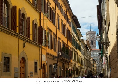 FLORENCE, ITALY - JUNE 1, 2019: The Via Di Ricasoli Runs Past The Famed Galleria Dell’Accademia Di Firenze, Which Contains Michelangelo’s David; The Cathedral Bell Tower Is Visible In The Distance.