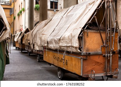 Florence, Italy, June 3, 2019: View Of Outdor Market Portable Stall Trolleys Packed Up Overnight And Waiting For The New Days Trading At A Plaza In The Centre Of Florence