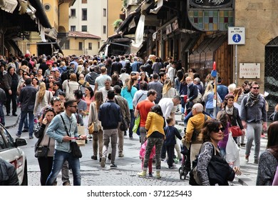 FLORENCE, ITALY - MAY 1, 2015: Crowd Of People Visits Ponte Vecchio In Florence, Italy. Italy Is Visited By 47.7 Million Tourists A Year (2013).