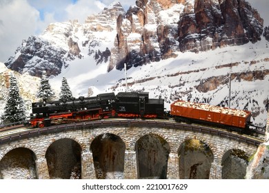 Florence, Italy - September 2022: Model Of A Steam Train Locomotive On A Viaduct In Winter Mountain Ambientation