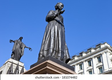 Florence Nightingale Statue With The Crimean War Memorial Behind.  Situated In Waterloo Place In London.