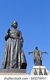 Florence Nightingale Statue With The Crimean War Memorial Behind.  Situated In Waterloo Place In London.